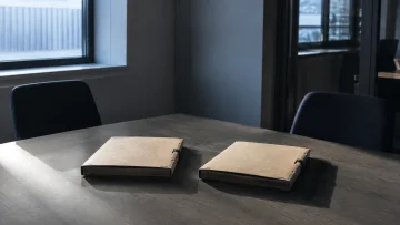 Twee dichte mappen op een lege vergadertafel